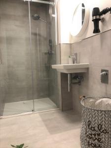 a bathroom with a shower and a sink at StadtHeimat29 in Münster