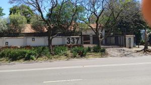a house with a sign on the side of a street at 337 Justice Mahomed Guest House in Pretoria