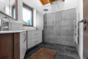 a bathroom with a shower and a sink at Ferienhaus 12 im Feriendorf Kirchdorf in Kirchdorf in Tirol