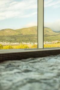 a bath tub with a view of mountains at Slieve Donard in Newcastle