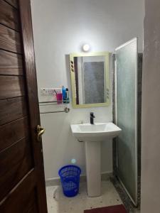 a bathroom with a sink and a mirror at The cliff room in Pongwe