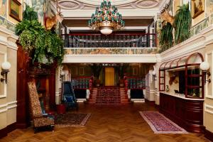 a hallway with a chandelier and stairs in a building at Slieve Donard in Newcastle