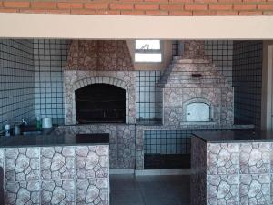 uma cozinha com um forno de pedra num quarto em casa c/4 dormitórios e piscina em Botucatu