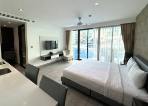 a bedroom with a large bed and a television at Direct pool access studio Twin Sands by Lofty in Patong Beach +17 photos