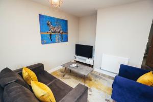 a living room with a couch and a tv at The Stay Company, Devonshire Court in Nottingham