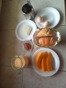 a table topped with plates of food with eggs and bread at Finca La Esperanza in Palora