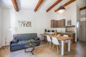 a living room with a couch and a table at Résidence Santa Monica in Bonifacio