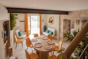 a living room with a table and chairs at Gites du Fort au Prince in Eymet