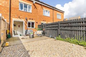 a backyard with two chairs and a fence at Modern 3 bedroom home *EVcharging* Garden, Parking in Darlington