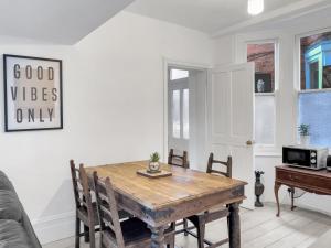 a dining room with a wooden table and chairs at Simply Hove By My Getaways in Brighton & Hove