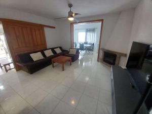 a living room with a couch and a fireplace at Apartamento Montemar I REA-MON2 in Castellón de la Plana