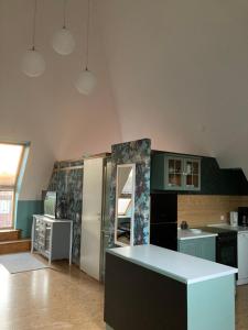 a kitchen with a refrigerator and a counter top at Pyramide Haus 51,8 in Bad Nenndorf