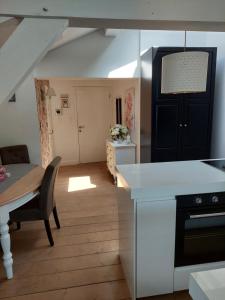 a kitchen with a table and a dining room at La chambre et le studio du château du golf de Bernalmont in Liège +20 photos