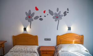 Postel nebo postele na pokoji v ubytování HOSTAL CACHE
