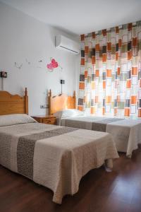 Postel nebo postele na pokoji v ubytování HOSTAL CACHE