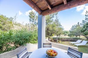 a table with a bowl of fruit on a patio at Résidence Santa Monica in Bonifacio