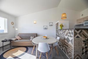 a living room with a table and a couch at Résidence Santa Monica in Bonifacio