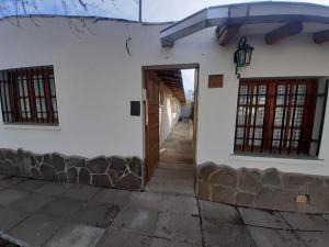 a view of the entrance to a white house at Abi in Esquel