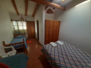 a room with two beds and two chairs in it at Abi in Esquel