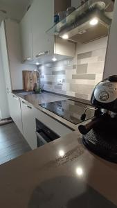 a kitchen with a stove and a counter top at Wake'n Bake Affittacamere in Genova