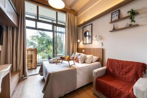 a hotel room with a bed and a chair at ARQ VILA MARIANA in Sao Paulo +64 photos