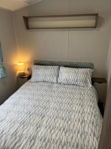 a bed with two pillows in a bedroom at BlackJak Retreat in Grange Over Sands