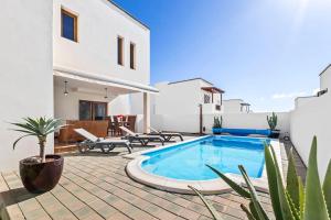 a villa with a swimming pool on a patio at Villa Nica in Costa Teguise