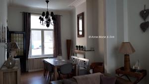 a living room with a table and a dining room at Huis Hersinde in Blankenberge