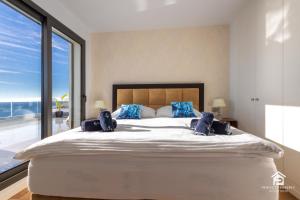 Un dormitorio con una cama grande con una ventana grande. en Luxury penthouse with huge terrace and sea and golf views, en San Roque 18 fotos más