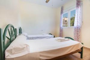 two beds in a hospital room with a window at Villa Garlanda - PlusHolidays in Benissa