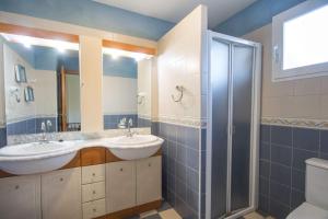 a bathroom with two sinks and a shower at Villa Garlanda - PlusHolidays in Benissa