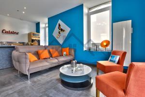 - un salon avec un canapé et des fauteuils orange dans l'établissement LocaLise - M2A - La maison bleue avec extérieur entièrement clos - Proche du centre et du port - Draps inclus - Animaux bienvenus, au Guilvinec