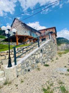 a building with a stone wall and a street light at Chalet Soubeyran in Guillaumes