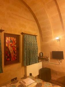 ネヴシェヒルにあるLovely Cappadocia Hotelの壁画のある窓付きの部屋