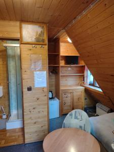 a room with a bed and a table in a cabin at Agroturystyka U BOŻENY in Przysłup