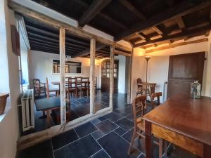 a living room with a dining room table and chairs at La maison d'à côté in Tellin +21 photos