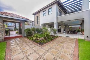 a house with a courtyard in front of it at Captivating 2-Bed Apartment in Sandton in Sandton