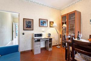 Zimmer mit einem Schreibtisch und einer Mikrowelle in der Unterkunft Casa tra gli ulivi vicino al mare in Seravezza