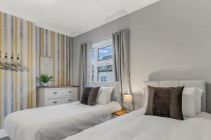 a bedroom with two beds and a window at Ashby House in Coalville