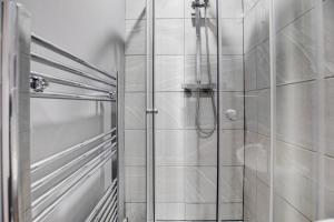 a shower with a glass door in a bathroom at Ashby House in Coalville