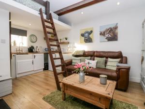 a living room with a couch and a coffee table at High Wreah Bolt Hole in Whitehaven