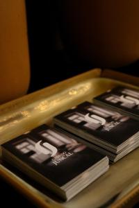 a pile of books sitting on top of a table at Casa do Juncal in Guimarães