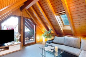 a living room with a couch and a tv at Cheng 2 in Baden-Baden