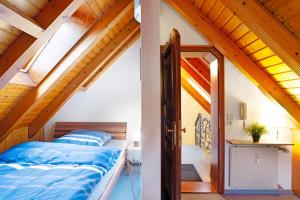 a bedroom in a attic with a bed and an open door at Cheng 2 in Baden-Baden