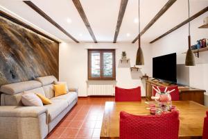 a living room with a couch and a table at La Casetta in Aosta