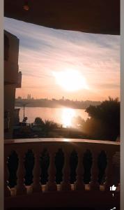 a view of a sunset from a balcony at Nile Sunrise Flats in Luxor