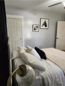 a bedroom with a bed with white sheets and pillows at DCU Center, Woo-Sox Stadium, Kelly square in Worcester