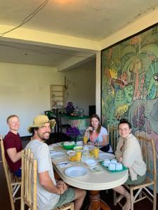 a group of people sitting around a table at Paradise view hostel in Ella