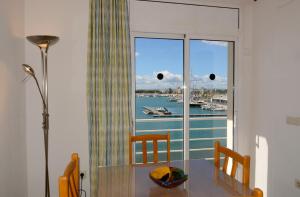 a dining room table with a view of a marina at Treputxell 1-1 in L'Estartit