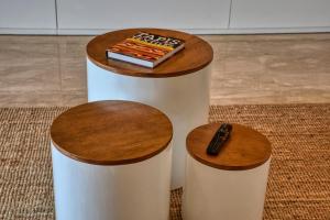 a remote control sitting on a table with two stools at Jad - Luxe - piscine - 6 Px in Agadir +88 photos